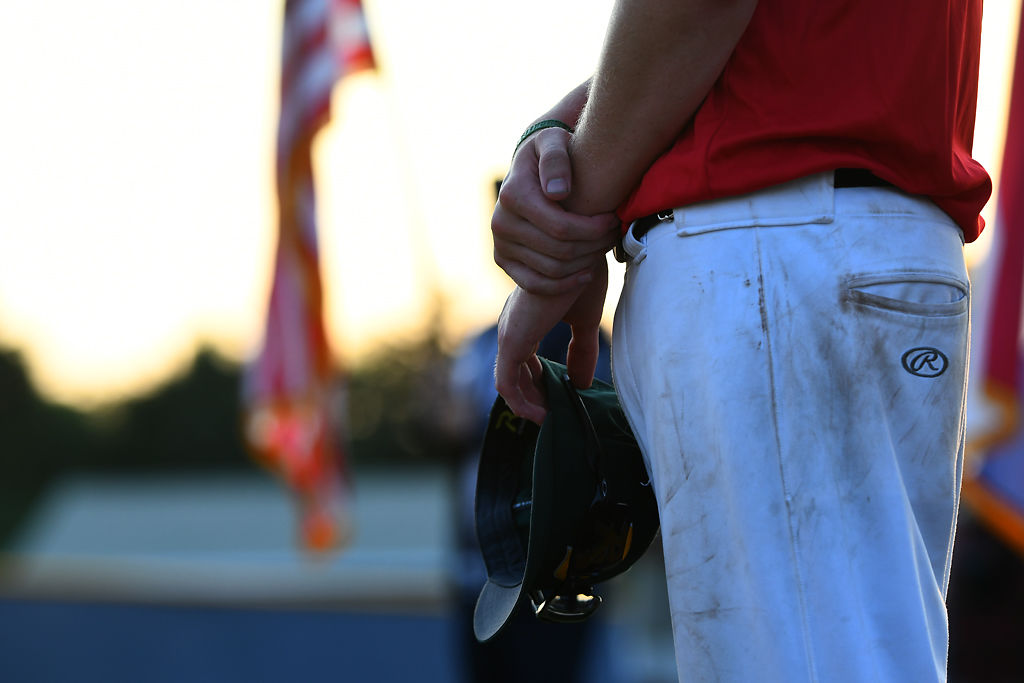 A Rock Bridge player holds his hat during a break in the game